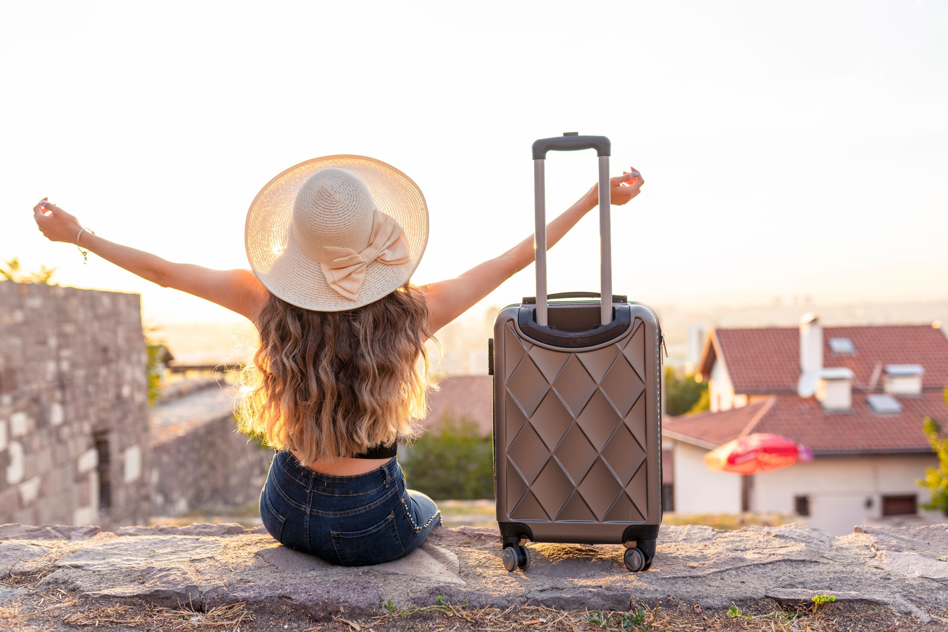 young blonde woman with suitcase travel on street